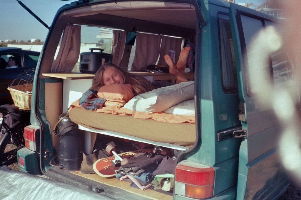Woman relaxing inside a vintage camper van